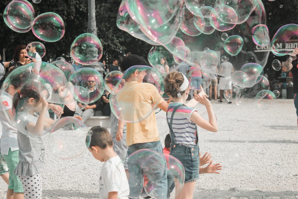 Kids enjoying sensory experiences playing with bubbles around them