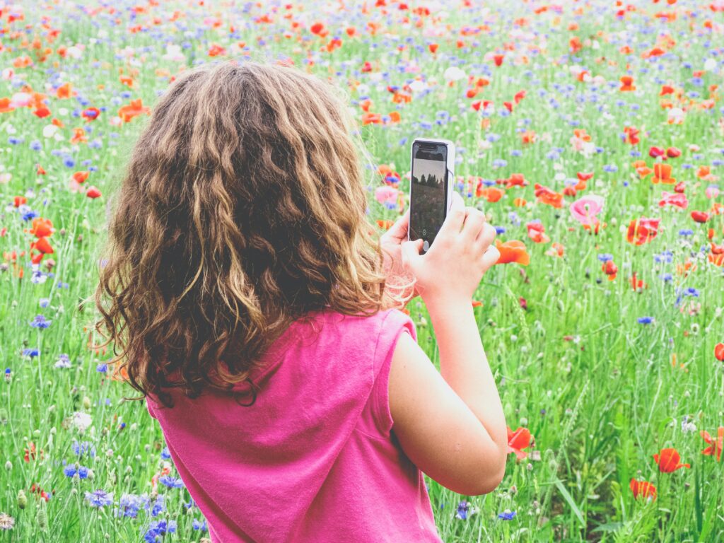 Young girl in a pasture of wild flowers cultivating awe