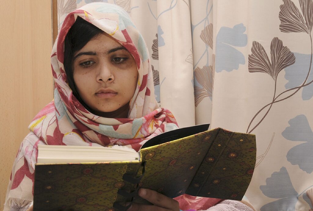 Malala Yousafzai reading her book I Am Malala: The Girl Who Stood Up for Education and Was Shot by the Taliban