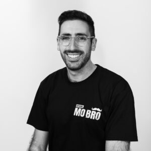 Photo of Zac Seidler wearing a 'Movember' t-shirt for the Passion Struck Podcast with John R. Miles episode 685 on the Hidden Crisis in Men’s Mental Health